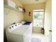 Well-lit laundry room with a window, washer, dryer, and storage shelves for supplies at 4698 Hannah Dr, Rock Hill, SC 29732