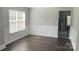 Inviting living room with beautiful wood floors, wainscoting detail, and large windows for natural light at 4698 Hannah Dr, Rock Hill, SC 29732