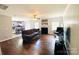 Open-concept living room featuring hardwood floors, a fireplace, and seamless transitions to the adjacent kitchen and dining area at 4698 Hannah Dr, Rock Hill, SC 29732
