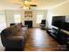 Spacious living room offering a fireplace, ceiling fan, hardwood floors, and a large window overlooking the backyard at 4698 Hannah Dr, Rock Hill, SC 29732
