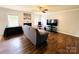 Cozy living room with hardwood floors, a fireplace, natural light from the windows, and a ceiling fan at 4698 Hannah Dr, Rock Hill, SC 29732