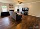 Spacious living room with hardwood floors, a ceiling fan, and a cozy fireplace at 4698 Hannah Dr, Rock Hill, SC 29732