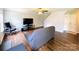 Bright living room featuring hardwood floors, a ceiling fan, and access to the home's front entrance and staircase at 4698 Hannah Dr, Rock Hill, SC 29732