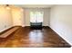 Bright living room featuring hardwood floors, neutral walls, and plenty of natural light from the large front windows at 4698 Hannah Dr, Rock Hill, SC 29732