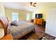 Inviting main bedroom featuring hardwood floors, two large windows, ceiling fan, and closet for ample storage at 4698 Hannah Dr, Rock Hill, SC 29732
