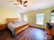 Comfortable main bedroom featuring hardwood floors, two large windows, and a ceiling fan to provide natural light at 4698 Hannah Dr, Rock Hill, SC 29732