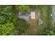 Aerial view of a home with a driveway, detached garage, and surrounding trees at 500 Peigler Nw St, Concord, NC 28027