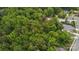 Aerial shot of a home surrounded by dense trees and greenery in a quiet neighborhood at 500 Peigler Nw St, Concord, NC 28027