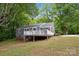 Gray house with a back deck and grassy lawn at 500 Peigler Nw St, Concord, NC 28027