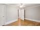 A quaint bedroom with hardwood floors and natural light from open doorway at 500 Peigler Nw St, Concord, NC 28027