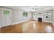 Sun-filled living room featuring hardwood floors, white trim, and multiple windows and doors at 500 Peigler Nw St, Concord, NC 28027
