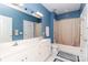 Bright bathroom featuring dual sinks, a bathtub with shower, and white tile flooring and cabinets at 532 Wilmslow Rd, Rock Hill, SC 29730