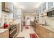 Bright kitchen featuring granite countertops, stainless appliances, and adjacent breakfast nook with door to a small patio at 532 Wilmslow Rd, Rock Hill, SC 29730
