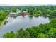 Aerial view of condos nestled on a lush lake, creating a serene and picturesque residential retreat at 5833 Harris Grove Ln, Charlotte, NC 28212