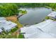 Stunning aerial perspective of waterfront condo community, highlighting a peaceful lake and lush green surroundings at 5833 Harris Grove Ln, Charlotte, NC 28212