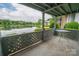 Enjoy a serene waterfront view from this cozy condo balcony with a small outdoor table at 5833 Harris Grove Ln, Charlotte, NC 28212