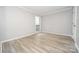 A bright bedroom with light gray walls and light-colored wood floors, offering a serene living space at 5833 Harris Grove Ln, Charlotte, NC 28212