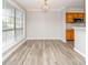 Dining area features hardwood floors, a large window, and view of the kitchen area at 5833 Harris Grove Ln, Charlotte, NC 28212