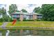 Charming two-story condo overlooking a pond with lush landscaping in a serene, wooded neighborhood at 5833 Harris Grove Ln, Charlotte, NC 28212