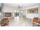 Open living room featuring a brick fireplace, ceiling fan, and view into the kitchen area at 5833 Harris Grove Ln, Charlotte, NC 28212
