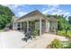 Outdoor covered patio with a grill, seating, and decorative plants for relaxing and entertaining at 6603 Havencrest Dr, Denver, NC 28037