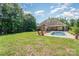 Spacious backyard with a pool, patio, and lush greenery, perfect for outdoor entertaining at 6603 Havencrest Dr, Denver, NC 28037