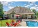 Outdoor pool area with lounge chairs, patio, and manicured lawn at 6603 Havencrest Dr, Denver, NC 28037