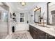 Bright bathroom with a tub under a window, a shower, and a double sink with a dark wood cabinet at 6603 Havencrest Dr, Denver, NC 28037
