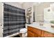 The bathroom features a shower, a toilet, a sink, and a decorative black and white shower curtain at 6603 Havencrest Dr, Denver, NC 28037
