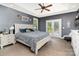 Calming main bedroom features a ceiling fan, tray ceiling, and lots of natural light at 6603 Havencrest Dr, Denver, NC 28037
