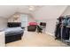 Bedroom with sloped ceilings featuring a bed, a recliner, a desk, and a garment rack with hanging clothes at 6603 Havencrest Dr, Denver, NC 28037
