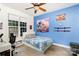 The bedroom features a single bed, a desk, and a blue accent wall decorated with anime and sword art at 6603 Havencrest Dr, Denver, NC 28037