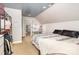 Bright bedroom with a bed, a vanity table with a lighted mirror, and a clothing rack at 6603 Havencrest Dr, Denver, NC 28037