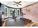 The workout room features a gym, a treadmill, an exposed brick wall, and three large windows at 6603 Havencrest Dr, Denver, NC 28037