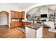 Open-concept kitchen with wood cabinets, granite counters, and stainless steel appliances at 6603 Havencrest Dr, Denver, NC 28037