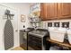 Functional laundry room with modern washer and dryer, built in cabinet and chevron decor at 6603 Havencrest Dr, Denver, NC 28037