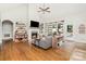 Inviting living room featuring hardwood floors, a fireplace, and ample natural light at 6603 Havencrest Dr, Denver, NC 28037