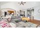 Open-concept living space with a large sofa, hardwood floors, and seamless flow to the kitchen at 6603 Havencrest Dr, Denver, NC 28037