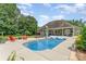 A backyard oasis with a sparkling pool, lounge chairs, and lush landscaping for summer enjoyment at 6603 Havencrest Dr, Denver, NC 28037