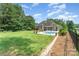 Landscaped backyard featuring a well-maintained lawn, pool and privacy fence for serene outdoor living at 6603 Havencrest Dr, Denver, NC 28037