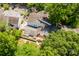Aerial view showcases fenced backyard, red brick patio and mature shade trees at 7129 Stonington Ln, Charlotte, NC 28227