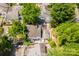 Backyard shot from above reveals a brick patio, fenced perimeter, and established trees at 7129 Stonington Ln, Charlotte, NC 28227