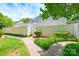A beautiful, fenced backyard with lush green grass and a concrete walkway at 7129 Stonington Ln, Charlotte, NC 28227