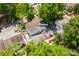 Aerial view reveals a fenced backyard, red brick patio, and lush shade trees at 7129 Stonington Ln, Charlotte, NC 28227