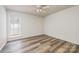 This bedroom is well lit with modern ceiling fan and new floors at 7129 Stonington Ln, Charlotte, NC 28227