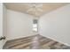 Bright bedroom with a ceiling fan and wood-look floors. Natural light from window at 7129 Stonington Ln, Charlotte, NC 28227