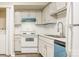 The new kitchen boasts updated white cabinets and a stylish blue dishwasher at 7129 Stonington Ln, Charlotte, NC 28227