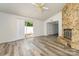 Bright living room with vinyl floors, stone fireplace, and sliding door to the patio at 7129 Stonington Ln, Charlotte, NC 28227