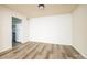 An empty living room leading to a kitchen with updated flooring at 7129 Stonington Ln, Charlotte, NC 28227