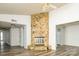A spacious living room featuring a stone fireplace and vinyl floors at 7129 Stonington Ln, Charlotte, NC 28227